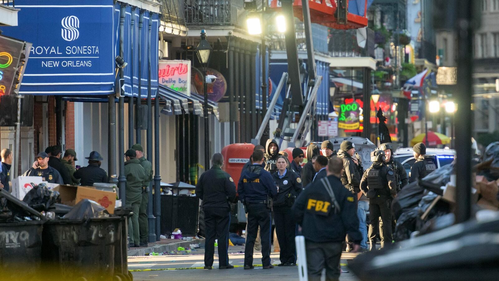 FBI investigators arrive at the scene where the white Ford F-150 pickup truck that crashed into a work lift after allegedly driving into a crowd of New Year's revelers in the French Quarter of New Orleans, Louisiana, on January 1, 2025. (Photo by Matthew HINTON / AFP)