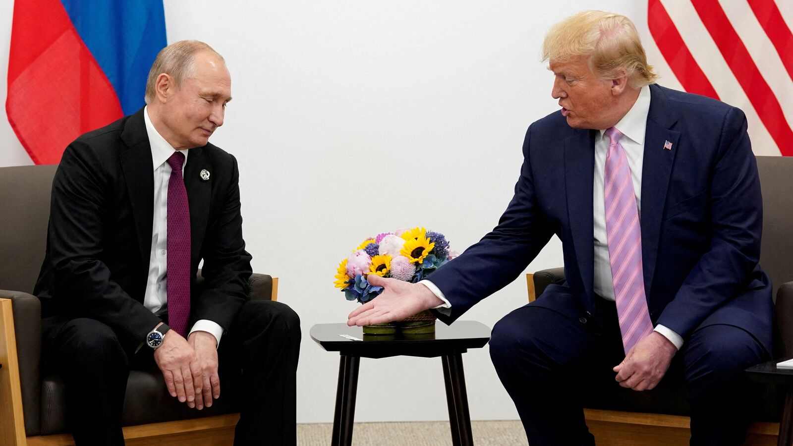 FILE PHOTO: Donald Trump, in his first term as U.S. president, gestures during a bilateral meeting with Russian President Vladimir Putin at the G20 leaders summit in Osaka, Japan, June 28, 2019.  REUTERS/Kevin Lamarque/File Photo