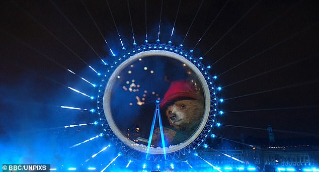 A huge show of fireworks lit up Big Ben in spite of storm warnings that forced many displays to be axed today, with many fans left stunned by a 'world-first' Paddington Bear cameo