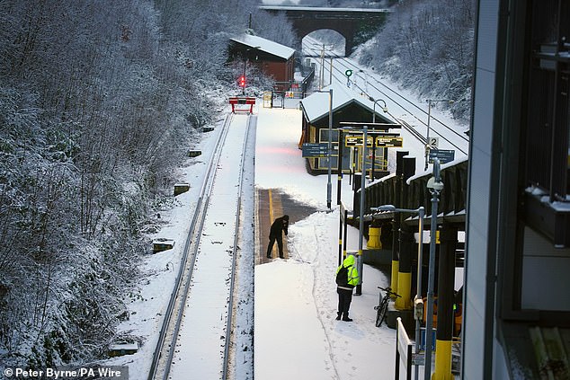 Trains were cancelled over the weekend after union bosses told drivers not to walk on snow (pictured: Hunt's Cross station on Sunday)