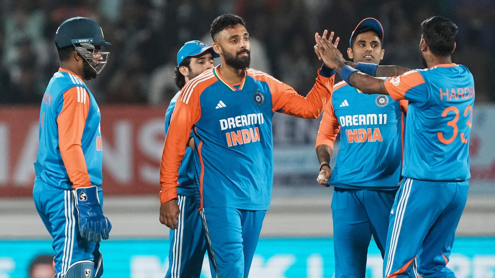 India's Varun Chakravarthy with teammates celebrates the wicket of England's Jofra Archer during their third T20I in Rajkot. 