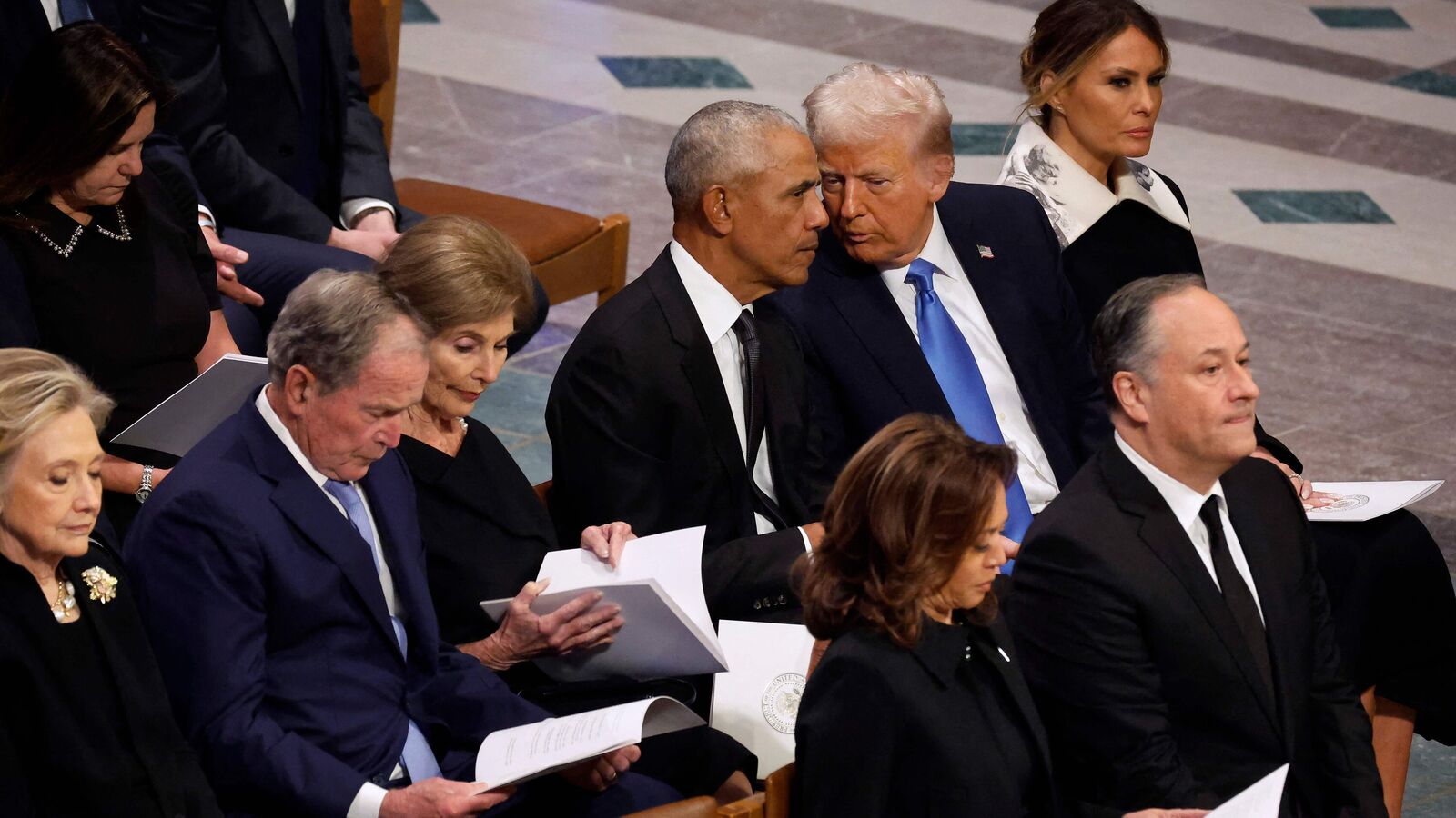 Former U.S. President Barack Obama (C) and U.S. President-elect Donald Trump visit while attending the state funeral for former U.S. President Jimmy Carter with (L-R) former Secretary of State Hillary Clinton, former President George W. Bush and Laura Bush, former first lady Melania Trump, Vice President Kamala Harris and second gentleman Doug Emhoff at Washington National Cathedral on January 09, 2025 in Washington, DC. Chip Somodevilla/Getty Images/AFP (Photo by CHIP SOMODEVILLA / GETTY IMAGES NORTH AMERICA / Getty Images via AFP)