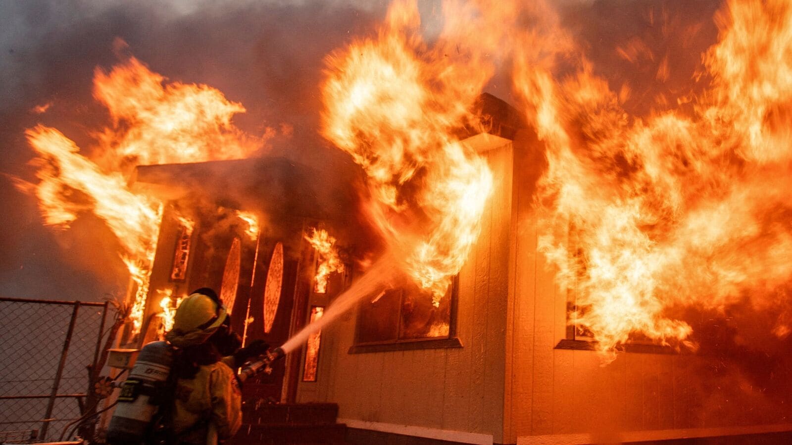 A firefighter battles the Palisades Fire as it burns during a windstorm on the west side of Los Angeles, California, US on January 7, 2025. 