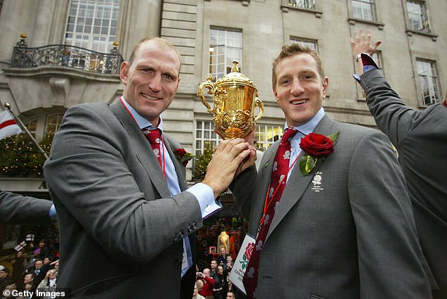 Dallaglio and Will Greenwood hold the Webb Ellis Cup during the England Rugby World Cup team victory parade December 8, 2003 in London