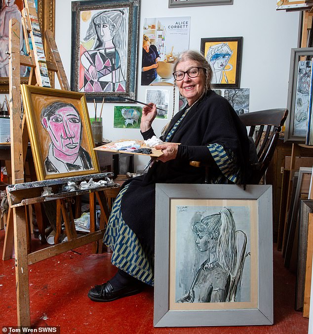 Lydia, former model of Spanish artist Pablo Picasso, stands in front of a photograph of herself (R) as she was posing as a young woman for the artist's work Sylvette