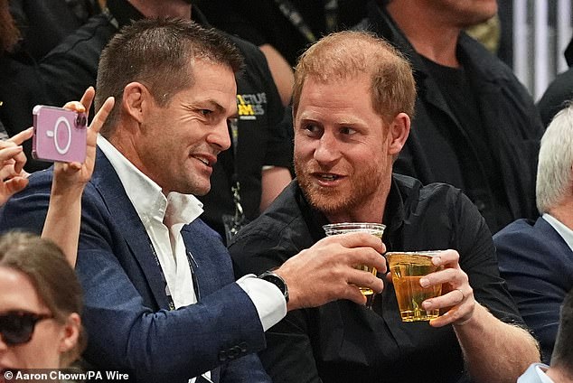 Harry watches the game in Vancouver with former All Blacks captain Richie McCaw.