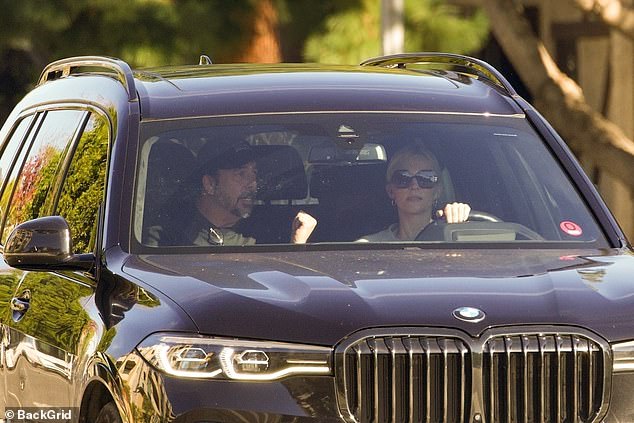 The mother-of-three kept sunglasses over her eyes and didn't appear to be wearing her wedding ring as she spoke to Grohl