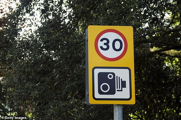 Pictured is a traffic sign warning of the speed limit and that cameras are in operation