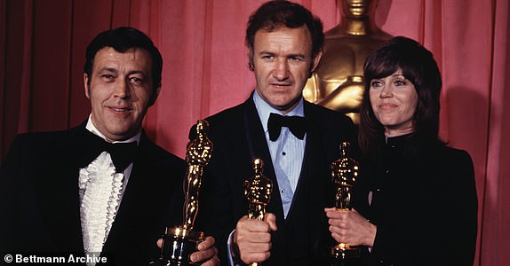 (Original Caption) Los Angeles, Calif,: Philip D' Antoni (left) and Gene Hackman, producer and star, respectively, of "best picture" The French Connection, hold Oscars they won-Hackman's for "best actor" at the 44th movie academy awards ceremony. Standing with them is Jane Fonda, who won "best actress" award for the movie Klute.