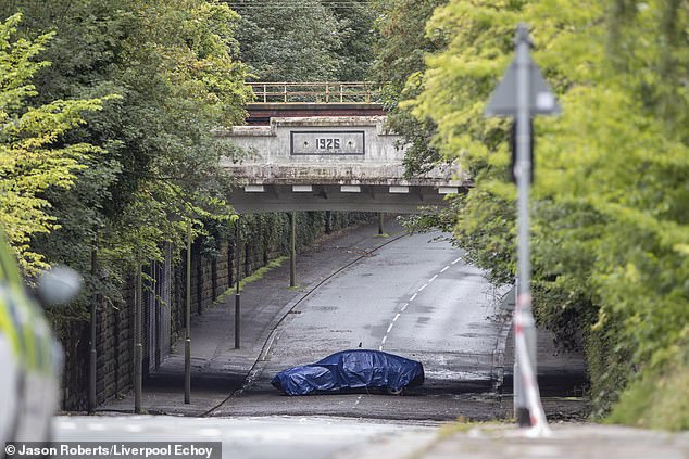 It has now been revealed that the couple's car (pictured) got trapped because the 'sewer network in the area cannot cope with the volume of water that falls in a short period of time', according to a Liverpool City Council report published today