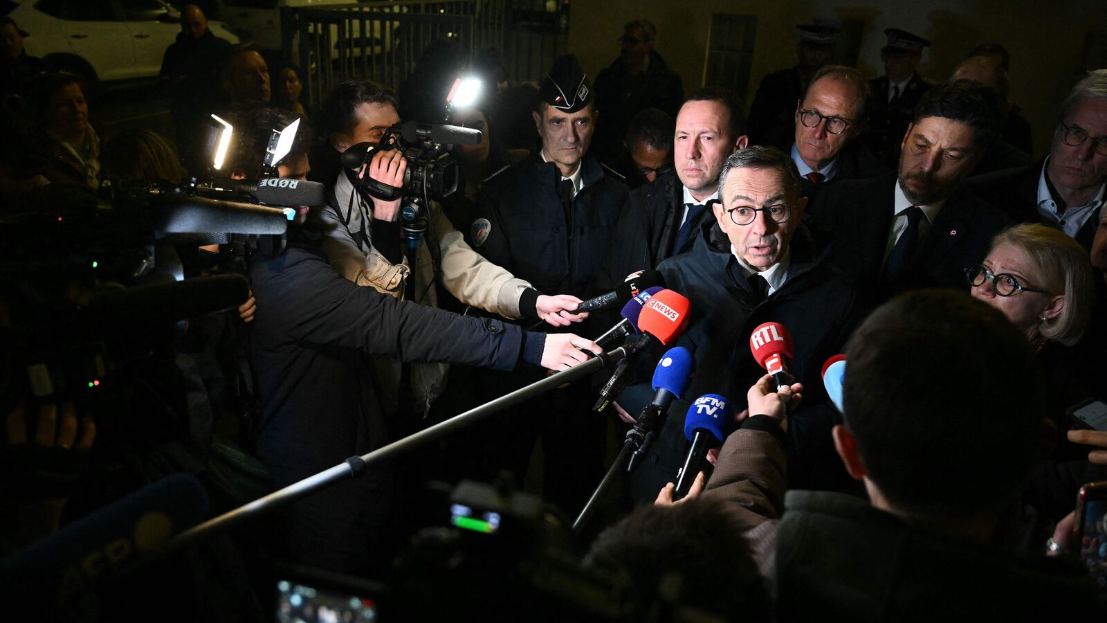 France's Minister of the Interior Bruno Retailleau (Centre R) addresses the press following a knife attack in Mulhouse. (Photo by AFP)