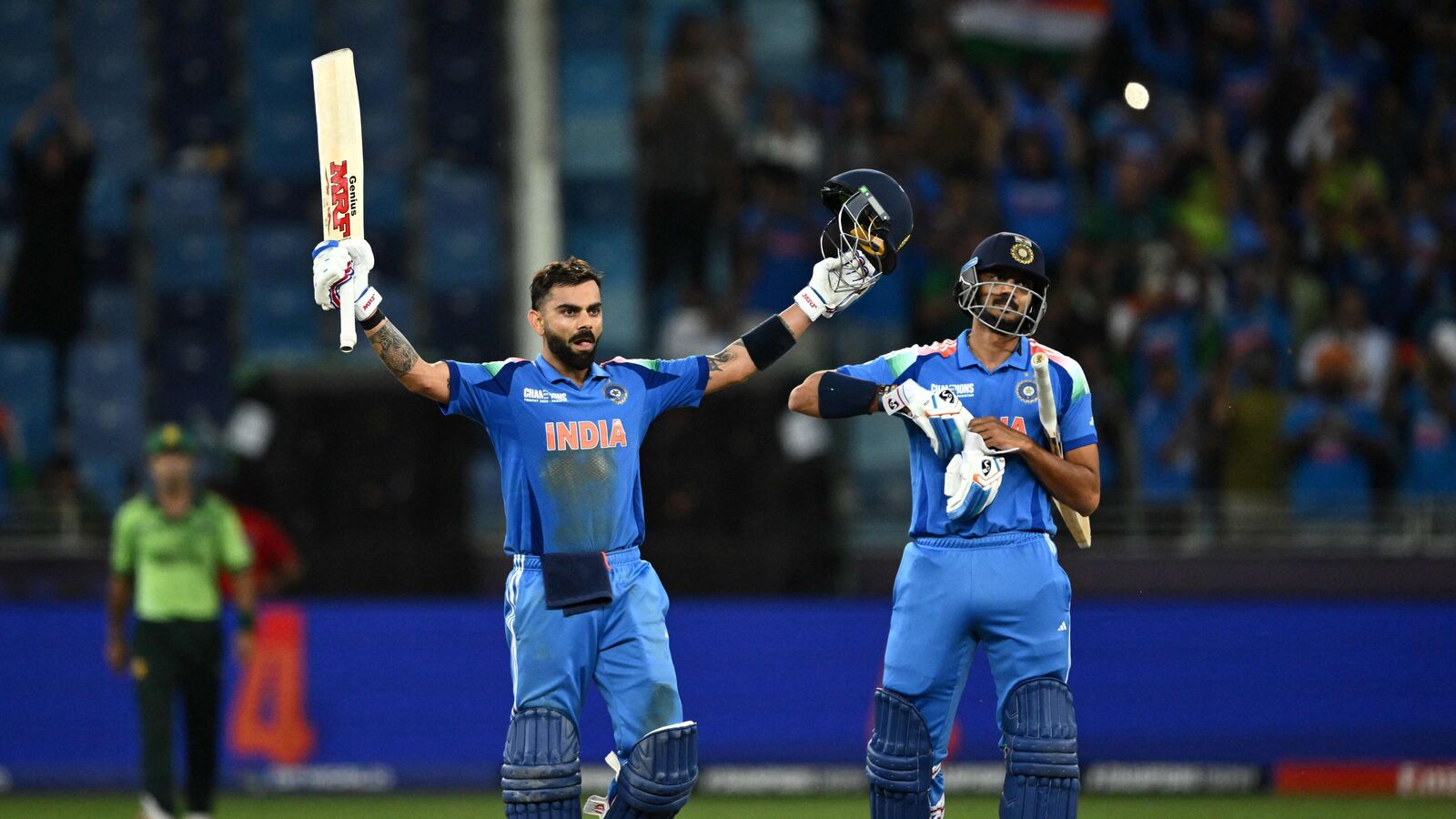 IND Vs PAK ICC Champions Trophy 2025: India's Virat Kohli (L) standing next to his teammate Axar Patel celebrates after scoring a century (100 runs) and their team's win at the end of the ICC Champions Trophy one-day international (ODI) cricket match between Pakistan and India at the Dubai International Stadium in Dubai on February 23, 2025. (Photo by Jewel SAMAD / AFP)