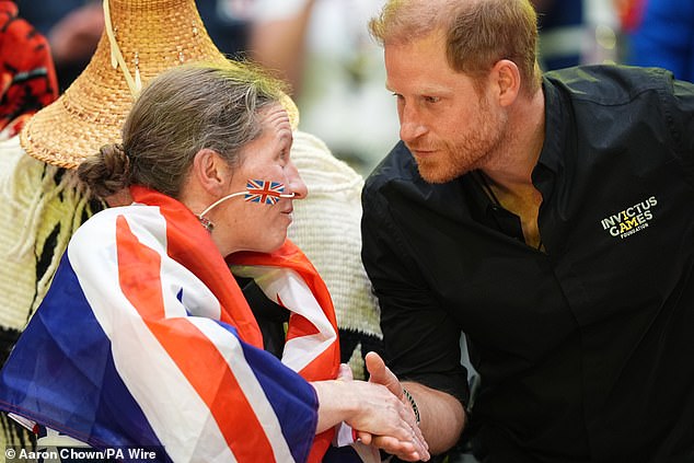 Harry with silver medallist Amanda Pye of the UK after the wheelchair rugby final yesterday