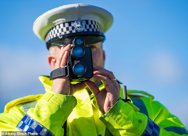 Pictured is a police officer checking car speeds in Edinburgh