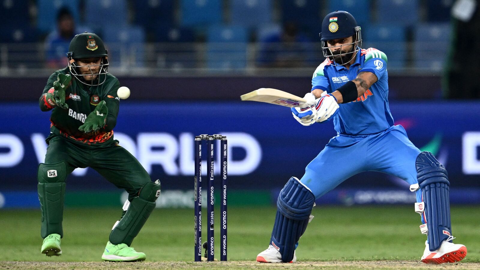 Virat Kohli (R) plays a shot during the ICC Champions Trophy 2025 clash against Bangladesh in Dubai.