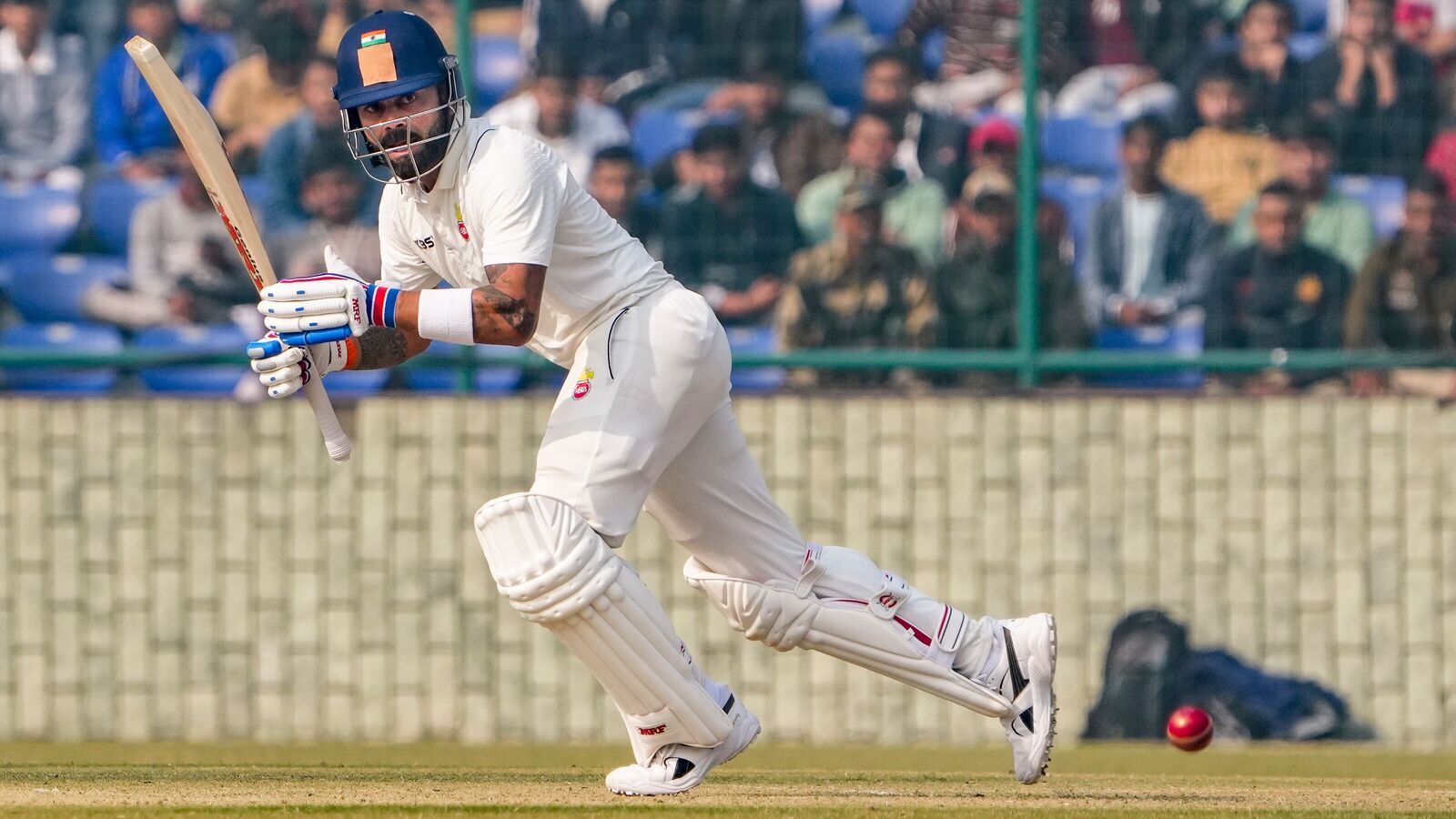 Delhi's Virat Kohli plays a shot on the second day of a Ranji trophy match against Railways, at the Arun Jaitley Stadium.