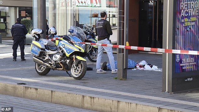 Police officers stand by during a major operation at the city center in Mannheim, Germany