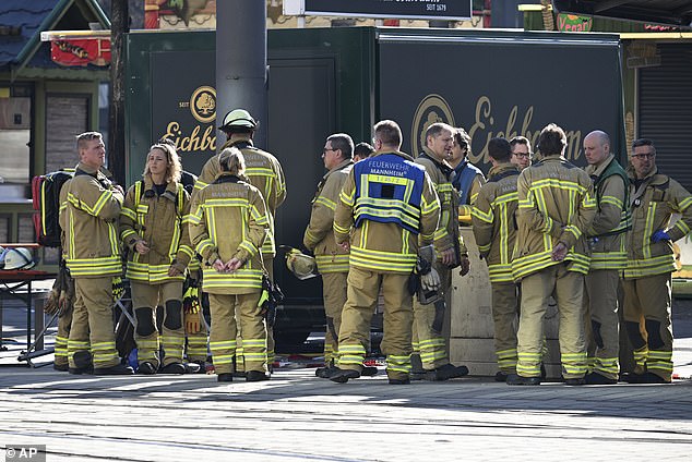 Emergency workers stand by during a major operation in the city center of Mannheim, Germany