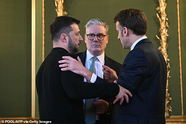 Ukraine's President Volodymyr Zelensky, Britain's Prime Minister Keir Starmer and France's President Emmanuel Macron embrace after holding a meeting during a summit at Lancaster House in central London on March 2, 2025