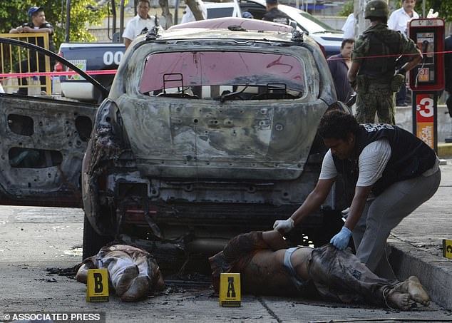 Bodies found next to a burned out vehicle. The heads were later found next to a primary school