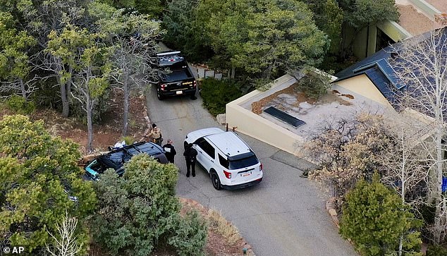 Police are seen outside Hackman's home on February 27 in Santa Fe, New Mexico. Authorities have confirmed that both Hackman and Arakawa 'tested negative for carbon monoxide'