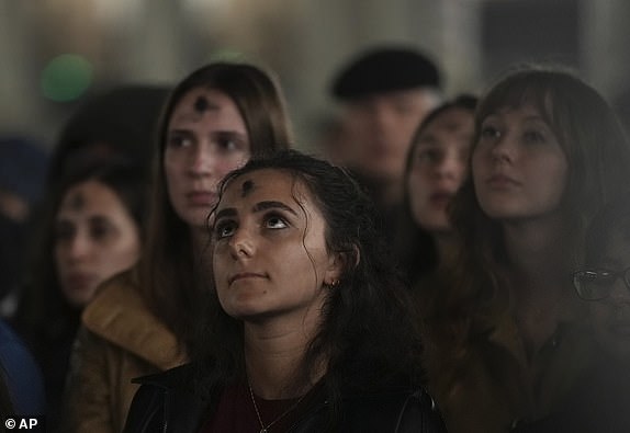 Girls, with ashes on their foreheads, pray during a rosary prayer for Pope Francis' health in St. Peter's Square at the Vatican, Wednesday, March 5, 2025. (AP Photo/Alessandra Tarantino)