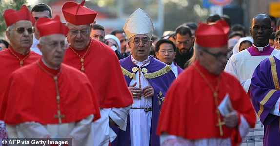 Italian cardinal Angelo De Donatis (C) arrives with a procession at the Church of Saint Sabina in Rome during the celebration of Ash Wednesday mass on March 5, 2025. Pope Francis's condition was stable on March 5, 2025 as he neared three weeks in hospital battling pneumonia, a Vatican source said, with celebrations for the Lent religious season starting without him. (Photo by Andreas SOLARO / AFP) (Photo by ANDREAS SOLARO/AFP via Getty Images)