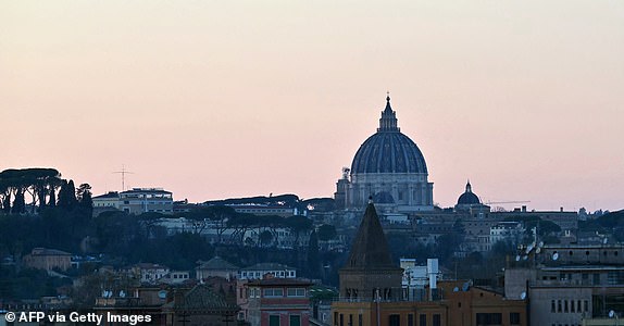 A picture shows the dome of St Peter's basilica in The Vatican at sunset as Pope Francis is still hospitalized with pneumonia, on March 5, 2025. Pope Francis's condition was stable on March 5, 2025 as he neared three weeks in hospital battling pneumonia, a Vatican source said, with celebrations for the Lent religious season starting without him. (Photo by Andreas SOLARO / AFP) (Photo by ANDREAS SOLARO/AFP via Getty Images)