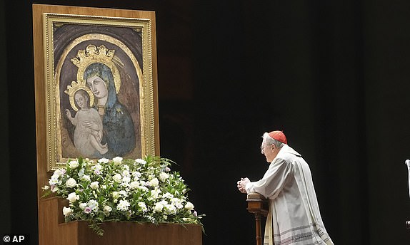 Cardinal Arthur Roche pray during a rosary prayer for Pope Francis' health in St. Peter's Square at the Vatican, Tuesday, March 4, 2025. (AP Photo/Alessandra Tarantino)