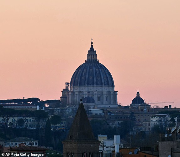 A picture shows the dome of St Peter's basilica in The Vatican at sunset as Pope Francis is still hospitalized with pneumonia, on March 5, 2025. Pope Francis's condition was stable on March 5, 2025 as he neared three weeks in hospital battling pneumonia, a Vatican source said, with celebrations for the Lent religious season starting without him. (Photo by Andreas SOLARO / AFP) (Photo by ANDREAS SOLARO/AFP via Getty Images)