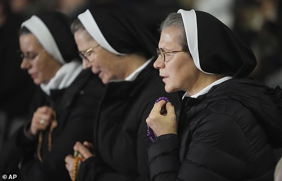 Nuns pray during a rosary prayer for Pope Francis' health in St. Peter's Square at the Vatican, Tuesday, March 4, 2025. (AP Photo/Alessandra Tarantino)