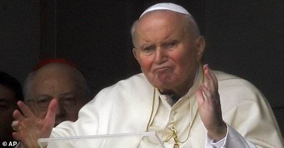 FILE - Pope John Paul II appears at a window of his rooms of the 10th floor of Rome's Gemelli Polyclinic Hospital, Sunday, March 13, 2005. (AP Photo/Lionel Cironneau, File)