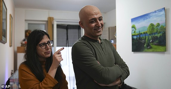 Hasan Zaheda and Nour Essa talk during am interview with the Associated Press in their house in Rome, Sunday, March 2, 2025. (AP Photo/Alessandra Tarantino)