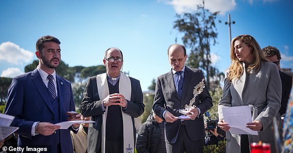 ROME, ITALY - MARCH 04: An Argentinian delegation pray below the sculpture of St. John Paul II at the main entry of the Policlinico A. Gemelli Hospital where Pope Francis is being cared for on March 04, 2025 in Rome, Italy. Pope Francis was hospitalised in Rome on February 14 with bronchitis, and later developed pneumonia in both his lungs. (Photo by Christopher Furlong/Getty Images)