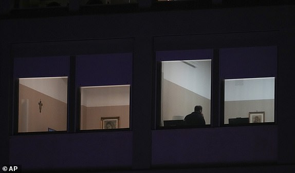 A man holds a mobile device in the ward where Pope Francis is hospitalized at the Agostino Gemelli Polyclinic, in Rome, Italy, Sunday, March 2, 2025. (AP Photo/Andrew Medichini)