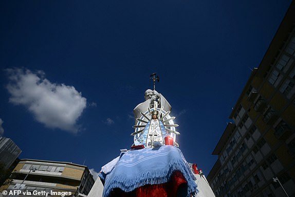 A picture shows a statue of Our Lady of Lujan in front of the statue of John Paul II outside the Gemelli University Hospital where Pope Francis is hospitalized with pneumonia, in Rome on March 04, 2025. Pope Francis "slept all night long" the Vatican said on March 4, 2025 after he suffered two breathing attacks on Monday, as the 88-year-old pontiff struggles to recover from pneumonia. (Photo by Filippo MONTEFORTE / AFP) (Photo by FILIPPO MONTEFORTE/AFP via Getty Images)