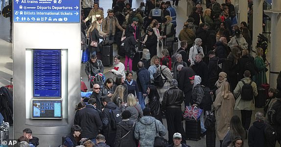 Passengers queue and wait near departures for Eurostar services at St Pancras International station in London, Friday March 7, 2025, after Eurostar trains to the capital have been halted following the discovery of an unexploded Second World War bomb near the tracks in Paris. (AP Photo/Frank Augstein)