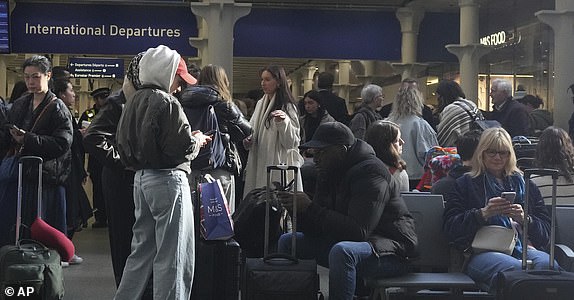 Passengers queue and wait near departures for Eurostar services at St Pancras International station in London, Friday March 7, 2025, after Eurostar trains to the capital have been halted following the discovery of an unexploded Second World War bomb near the tracks in Paris. (AP Photo/Frank Augstein)