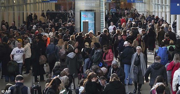 Passengers queue and wait near departures for Eurostar services at St Pancras International station in London, Friday March 7, 2025, after Eurostar trains to the capital have been halted following the discovery of an unexploded Second World War bomb near the tracks in Paris. (AP Photo/Frank Augstein)