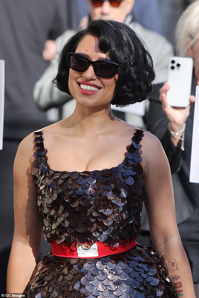 She seemed to be in very high spirits as she made her way around the star-studded French event, adding sunglasses as she posed up a storm outside