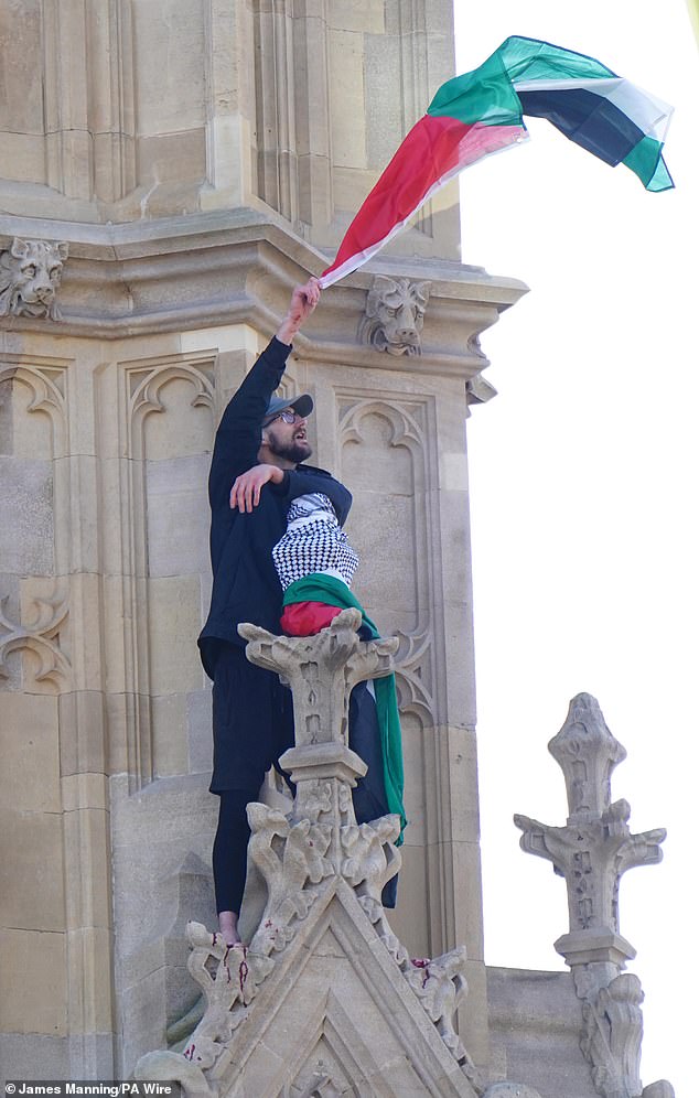 Londoners watched in shock as the man scaled part of the 96-metre-high structure, whilst waving a Palestinian flag