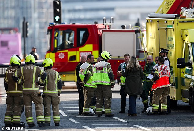 Westminster Bridge has been cordoned off as they attempt to retrieve the man from the side of the building