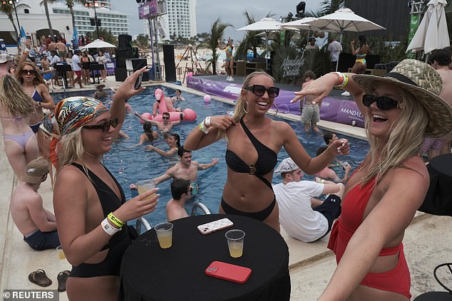 A group of college students dancing in Cancun. Spring Break is nutritious is the US for being a time when college students travel to sunny destinations to drink and party excessively away from the prying eyes of their parents