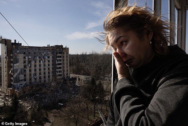 Iryna Petrochenko , 50, looks out from damaged apartment after a Russian missile attack happened killing a 47 year old woman and wounding nine others on March 12, 2025 in Kryvyi Rih, Ukraine