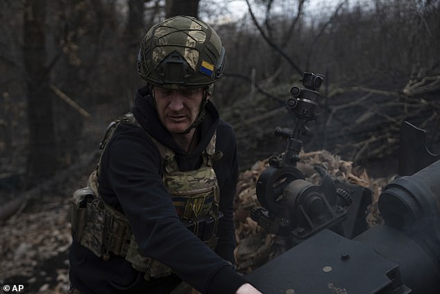 Ukrainian serviceman of Khartia brigade known by call sign 'Krystal' check M101 Howitzer after firing towards Russian positions in Kharkiv region, Ukraine, Wednesday, March 12, 2025