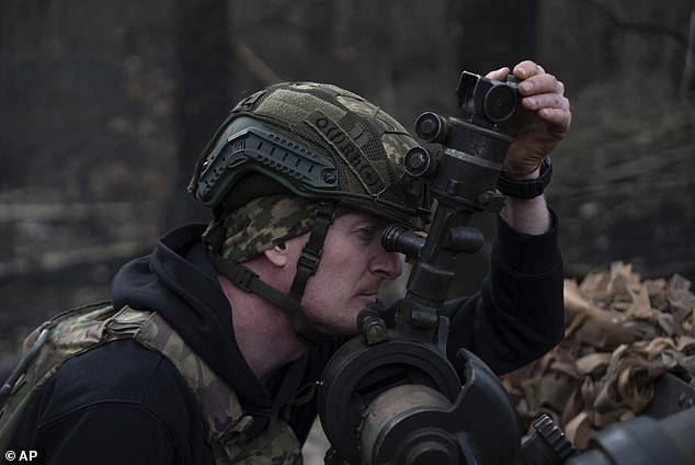 Ukrainian serviceman of Khartia brigade known by call sign 'Krystal' aims the M101 Howitzer towards Russian positions in Kharkiv region, Ukraine, Wednesday, March 12, 2025