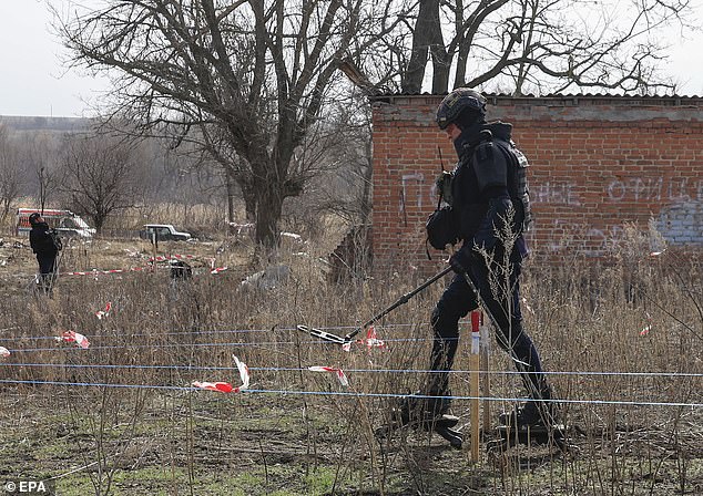 A Ukrainian sapper in special shoes walks during demining operations in the Kharkiv area, northeastern Ukraine, 12 March 2025