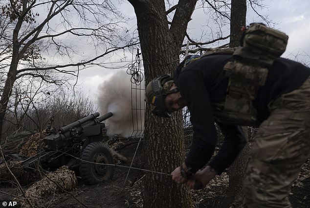 Ukrainian serviceman of Khartia brigade known by call sign "Krystal" fires M101 Howitzer towards Russian positions in Kharkiv region, Ukraine, Wednesday, March 12, 2025