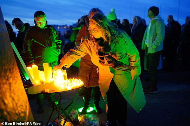 People light candles during a vigil in memory of Claire Chick organised by her daughters Bethany and Lydia at Smeaton's Tower lighthouse on Plymouth's Hoe