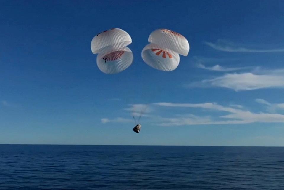 The Crew Dragon capsule containing Butch Wilmore and Suni Williams and two other astronauts descends by parachute before their splashdown off the coast of Florida. The landing came after a 17-hour voyage through the cosmos after undocking from the International Space Station.